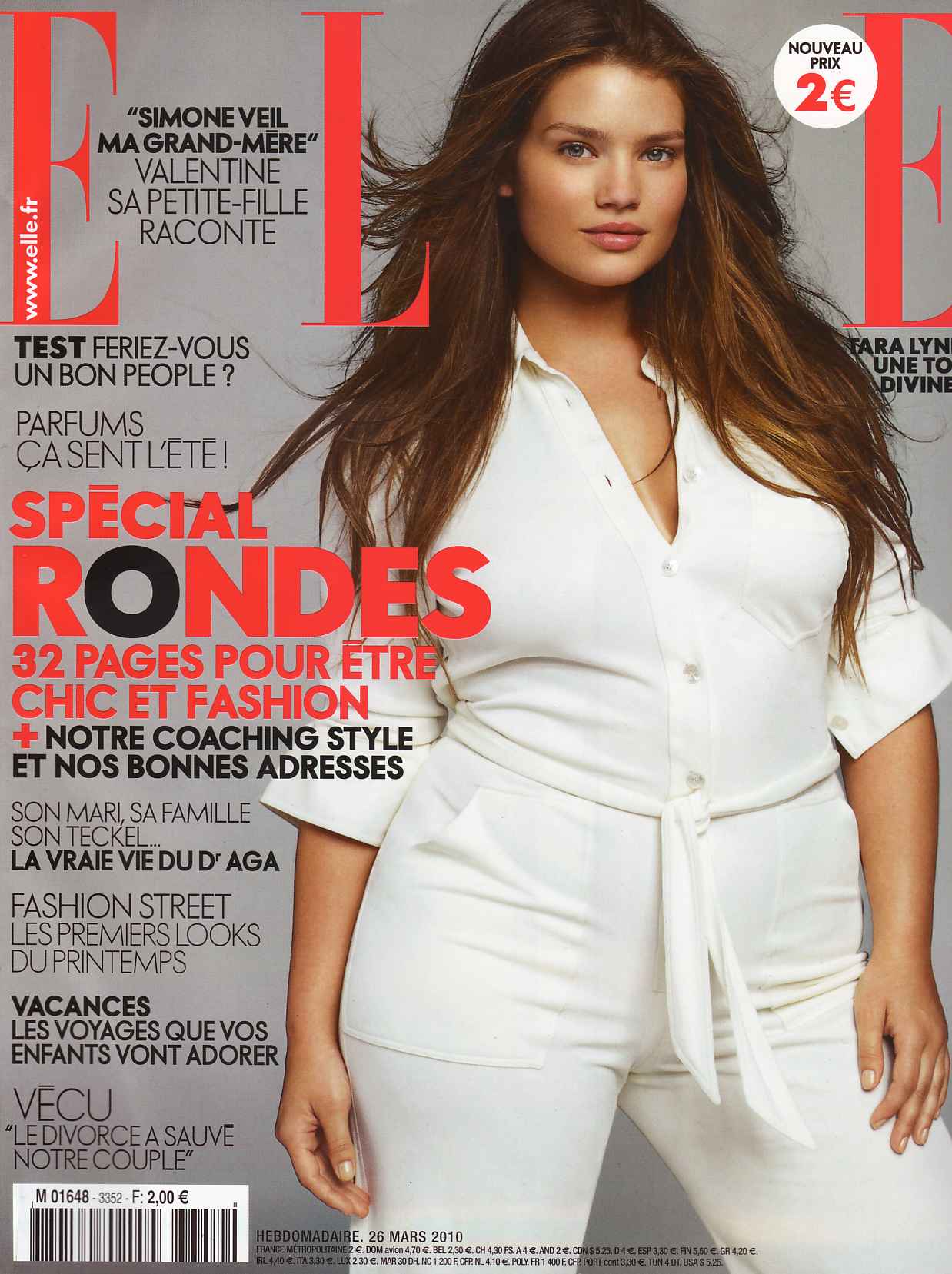Tara Lynn en couverture ELLE mars 2010, tenue blanche élégante, cheveux longs, mise en avant spécial rondes chic.